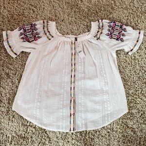 Cream Anthropologie top with colored detail